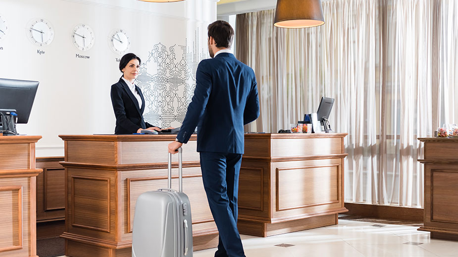 Attractive receptionist looking at businessman