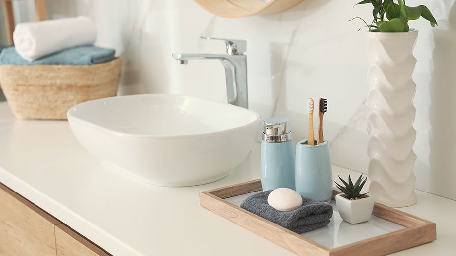 Countertop with sink and toiletries in bathroom